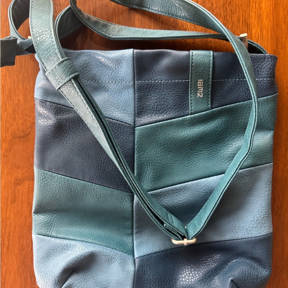 Zwei crossbody purse. New without tags. 3 pretty colors, 10x12 inches. Slim